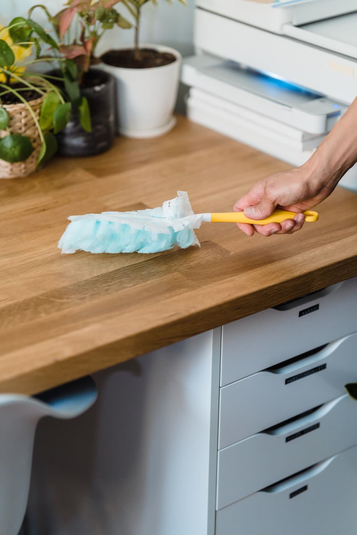 Dusting a workstation in a modern office