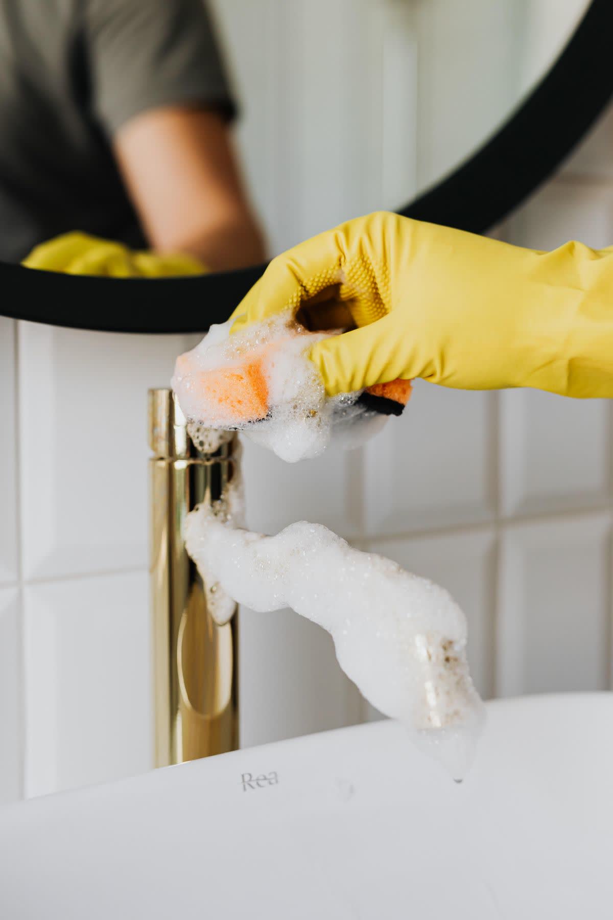 Deep-cleaning a gold bathroom faucet until it shines