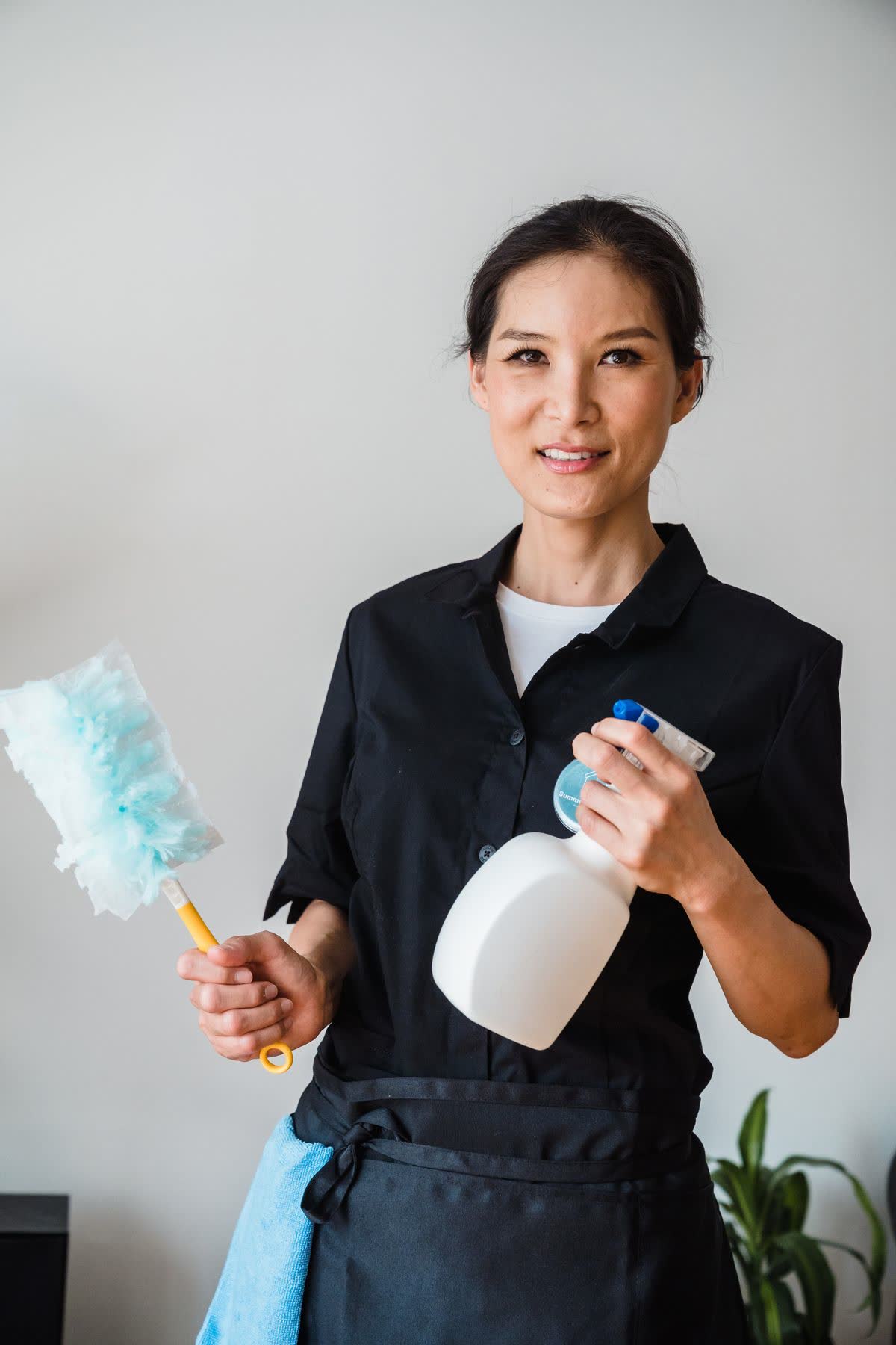 Austin Pro cleaning professional in uniform, smiling with supplies